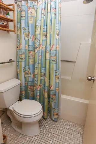 a bedroom with two beds and a painting on the wall