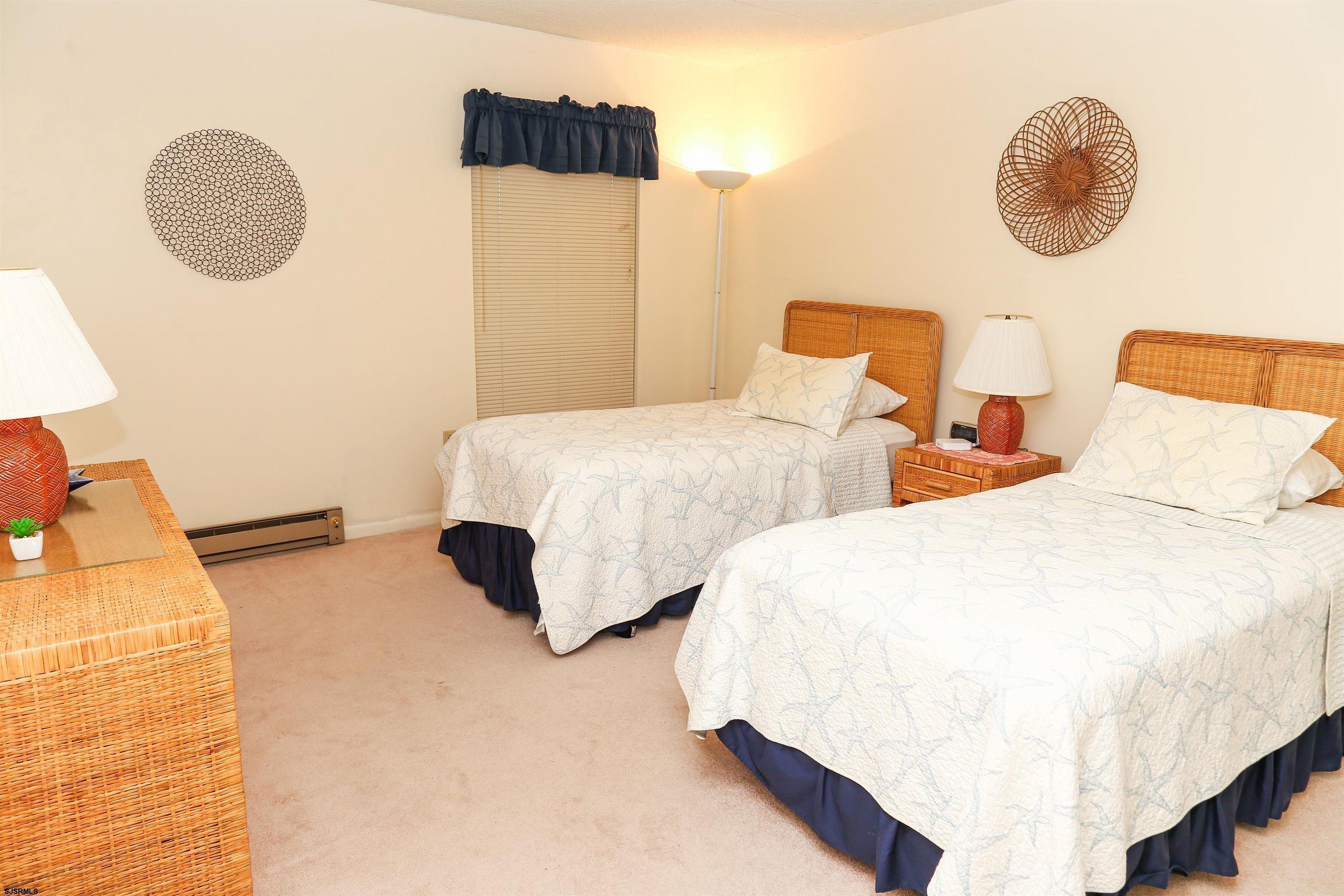 4540 West Brigantine Avenue, Unit N408 Brigantine, NJ 08203 - Photo 37 of 42 a bedroom with two beds and a painting on the wall