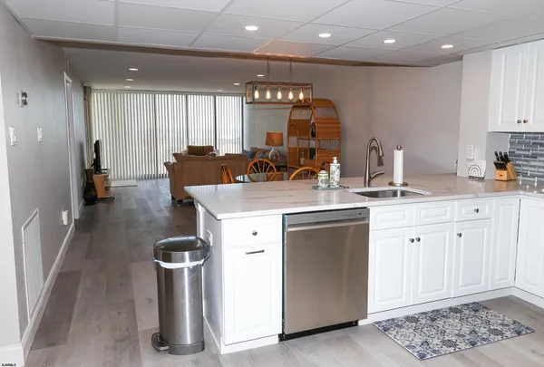 a kitchen with a sink appliances and cabinets