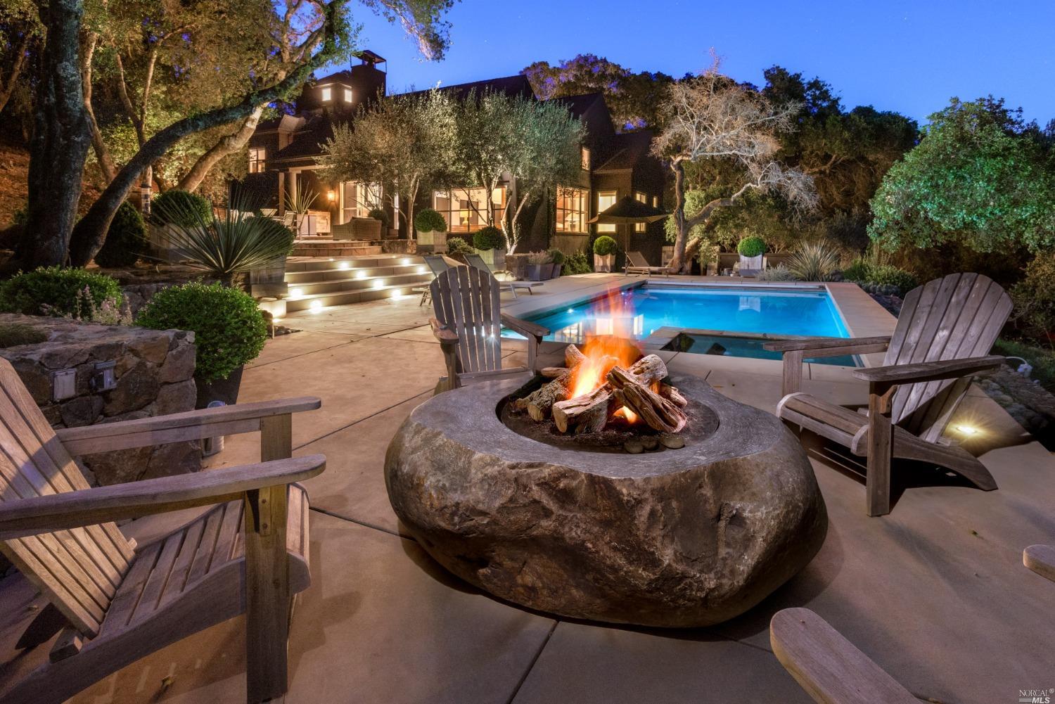 a view of a chairs and table in backyard