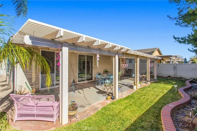 a view of a house with backyard porch and sitting area