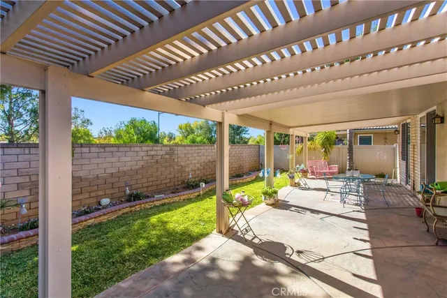 a view of a patio with a table chairs and a backyard