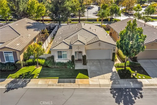 an aerial view of multiple houses with a yard