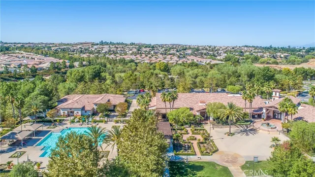 an aerial view of residential houses with outdoor space and trees
