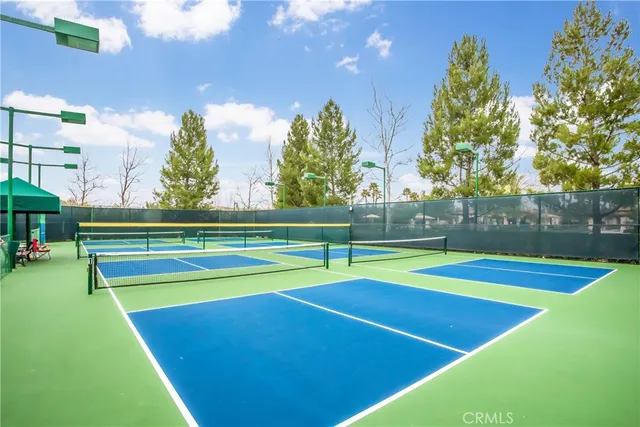 a view of a garden with a bench in front of house