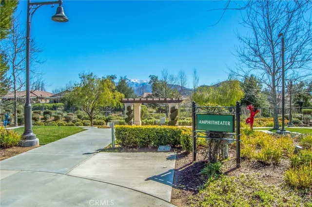 a view of swimming pool with a backyard and trees