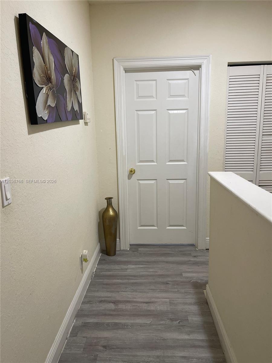 2432 Southwest 99th Way Miramar, FL 33025 - Photo 12 of 17 a view of a hallway with wooden floor and closet
