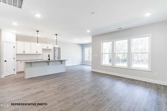 a view of kitchen with wooden floor and window