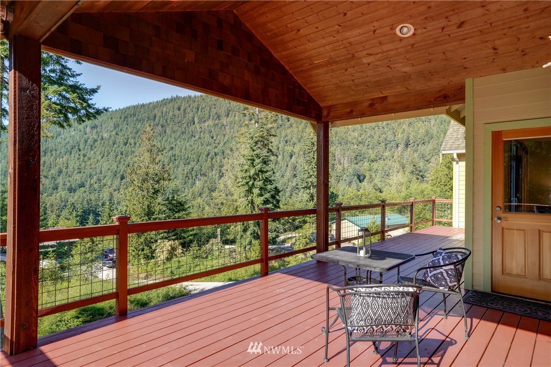 610 Chuckanut Heights Road Bellingham, WA 98229 - Photo 22 of 24 a view of balcony with wooden floor and outdoor seating