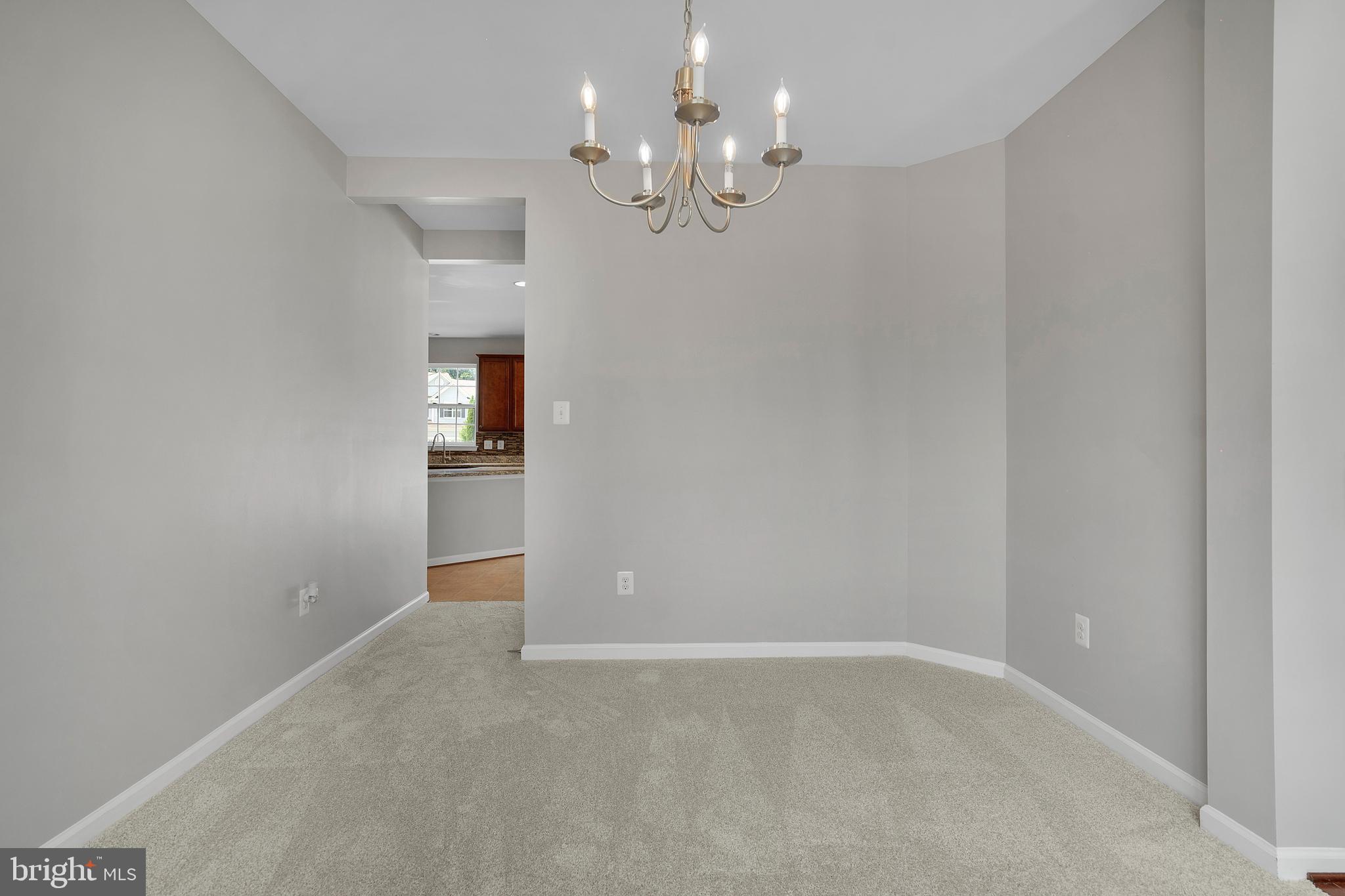 8205 Running Spring Circle Severn, MD 21144 - Photo 13 of 77 en empty room with chandelier fan