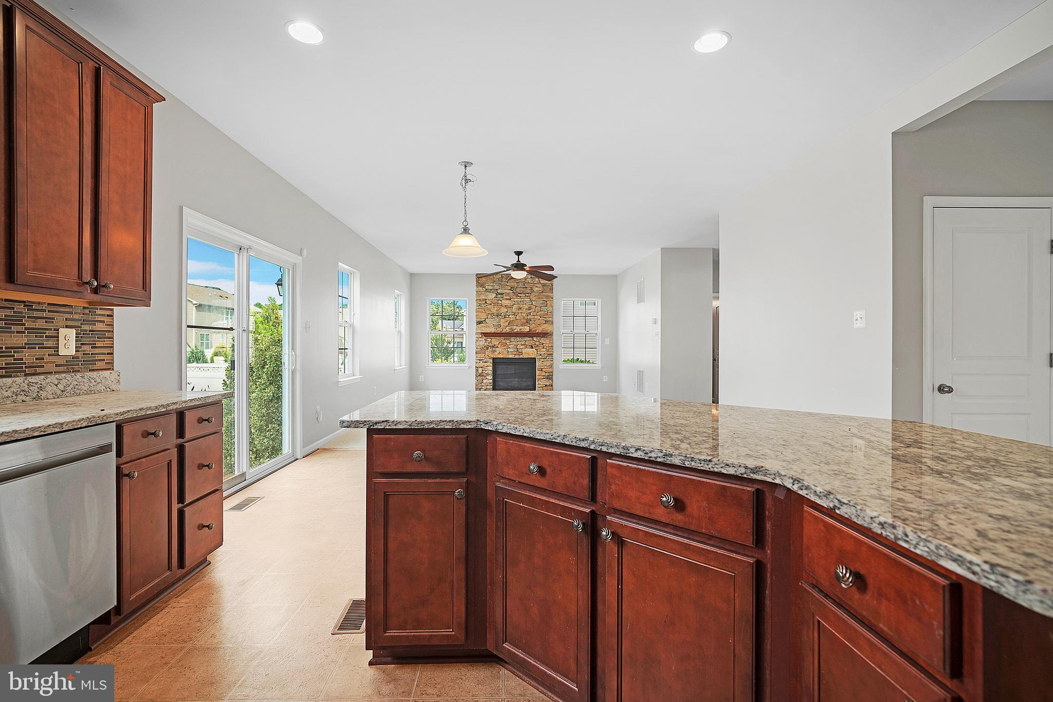 8205 Running Spring Circle Severn, MD 21144 - Photo 32 of 77 a kitchen with granite countertop cabinets stainless steel appliances a sink and a counter top space