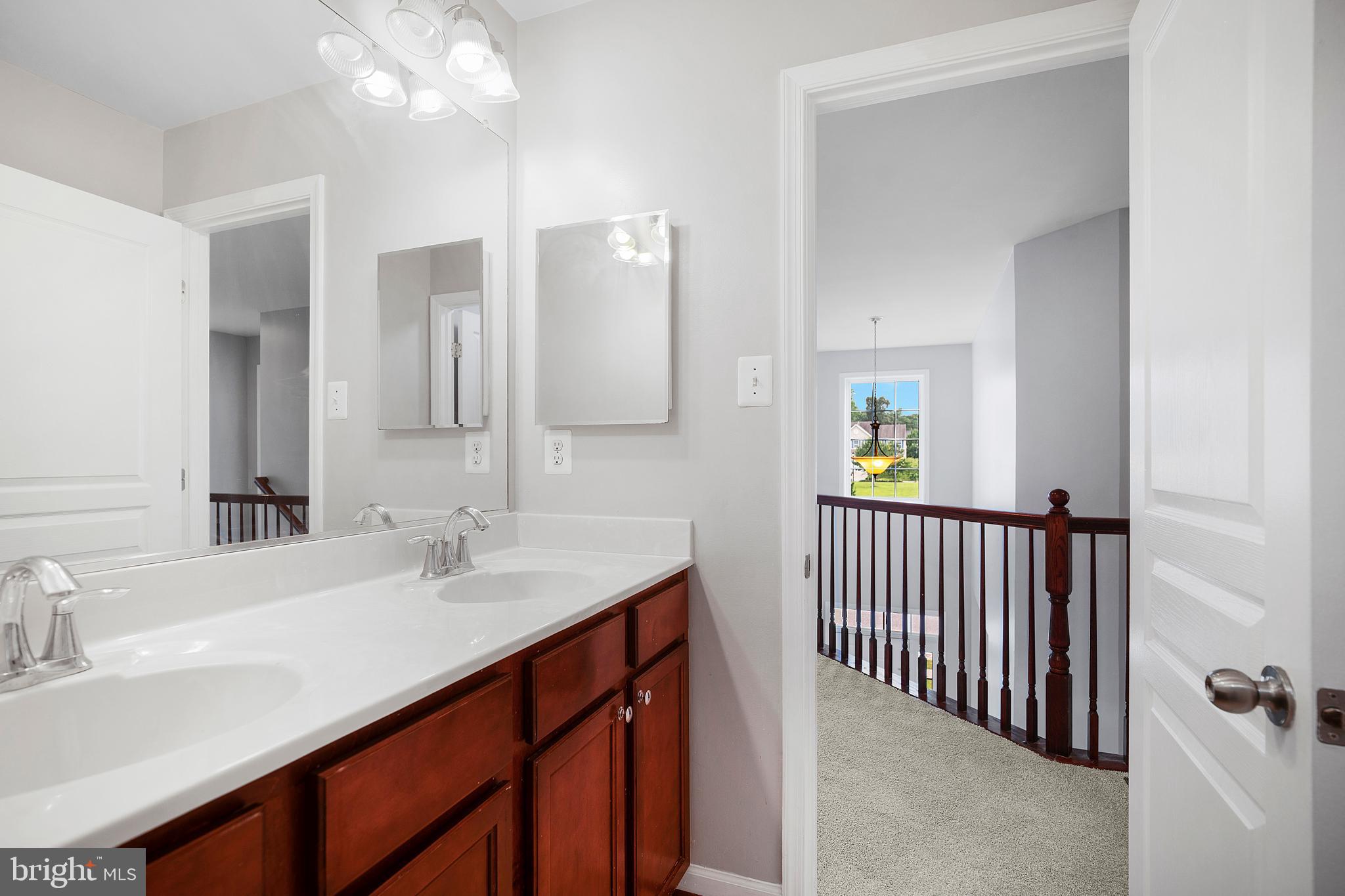 8205 Running Spring Circle Severn, MD 21144 - Photo 65 of 77 a bathroom with a sink vanity and a mirror
