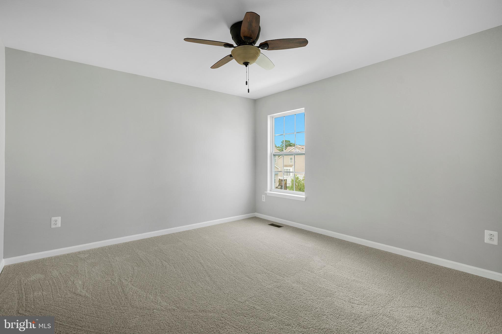 8205 Running Spring Circle Severn, MD 21144 - Photo 66 of 77 an empty room with a window and a fan