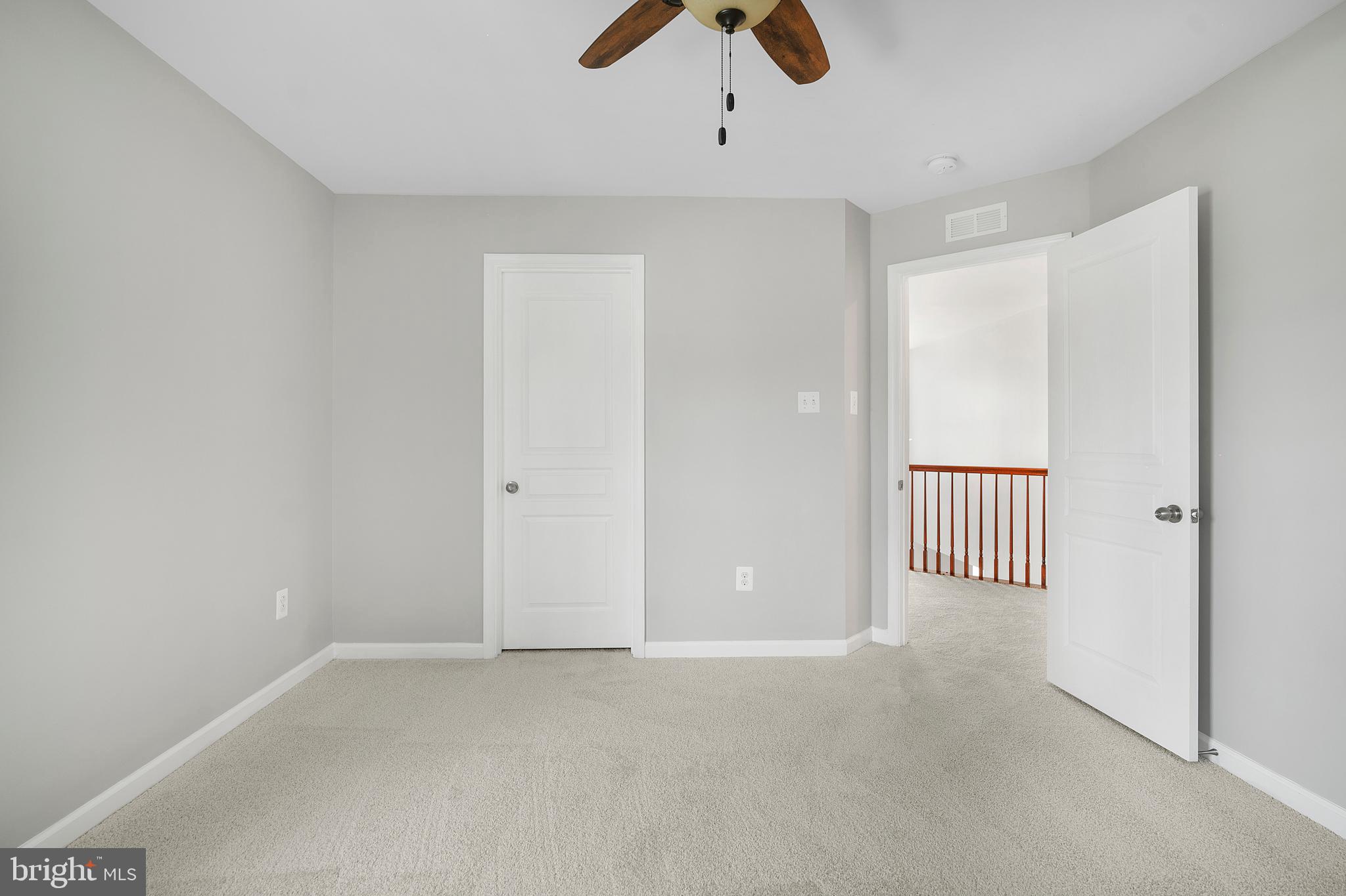8205 Running Spring Circle Severn, MD 21144 - Photo 67 of 77 an empty room with chandelier fan and windows