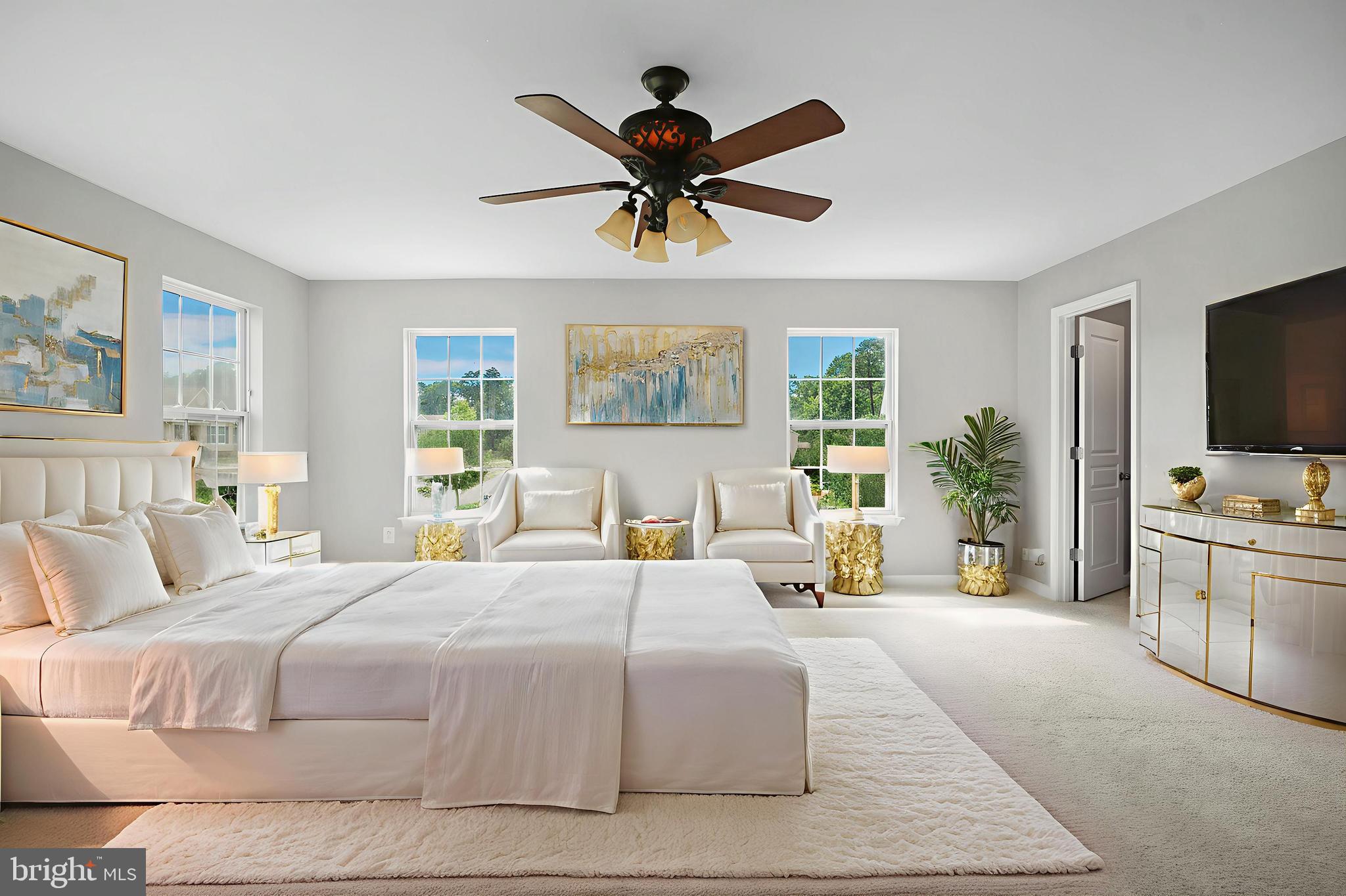 8205 Running Spring Circle Severn, MD 21144 - Photo 7 of 77 a bedroom with a large bed a flat screen tv and a couch