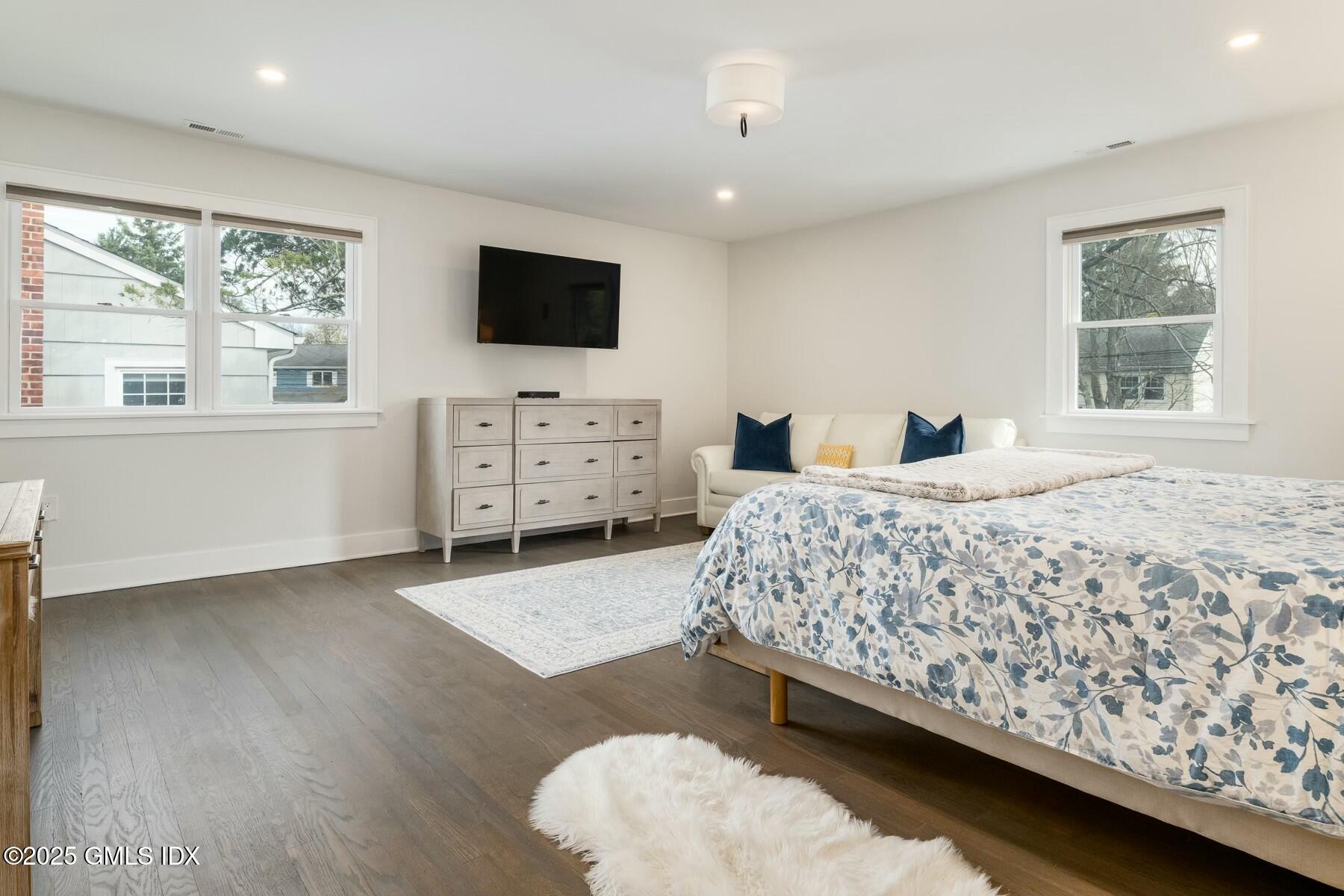 7 Griffith Road Riverside, CT 06878 - Photo 13 of 30 a bedroom with a bed and a flat screen tv