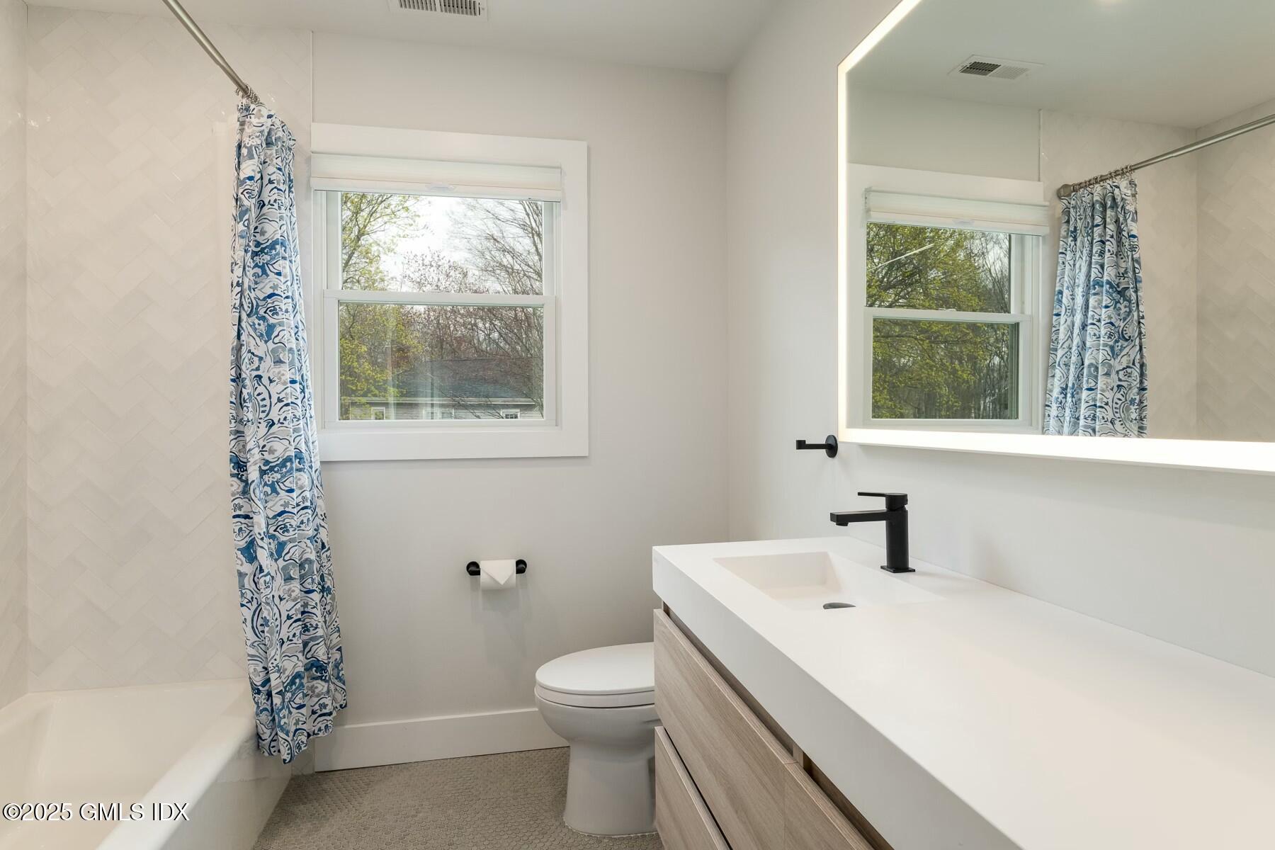 7 Griffith Road Riverside, CT 06878 - Photo 19 of 30 a white toilet sitting next to a bathroom sink