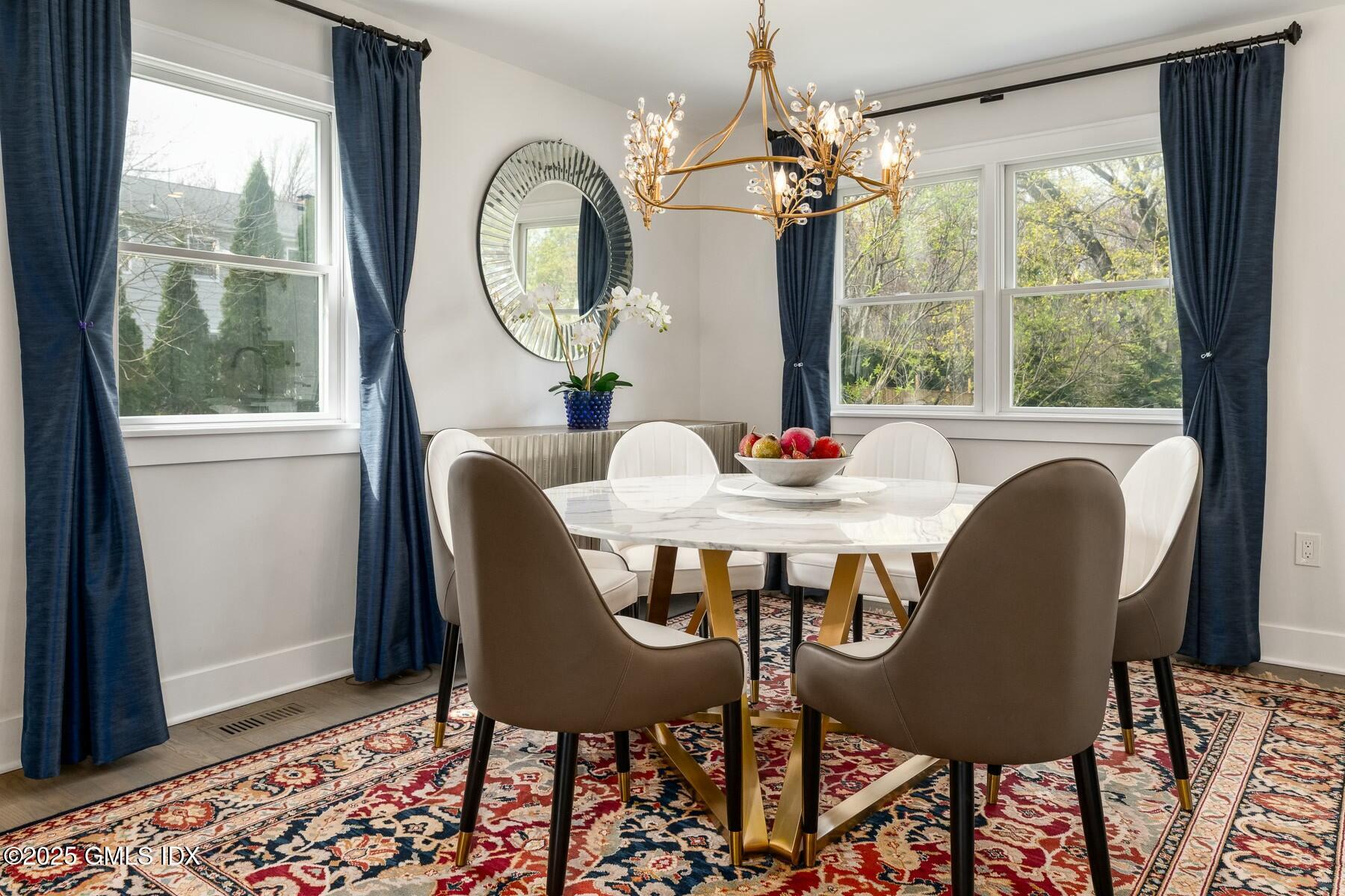 7 Griffith Road Riverside, CT 06878 - Photo 8 of 30 a view of a dining room with furniture a chandelier and wooden floor