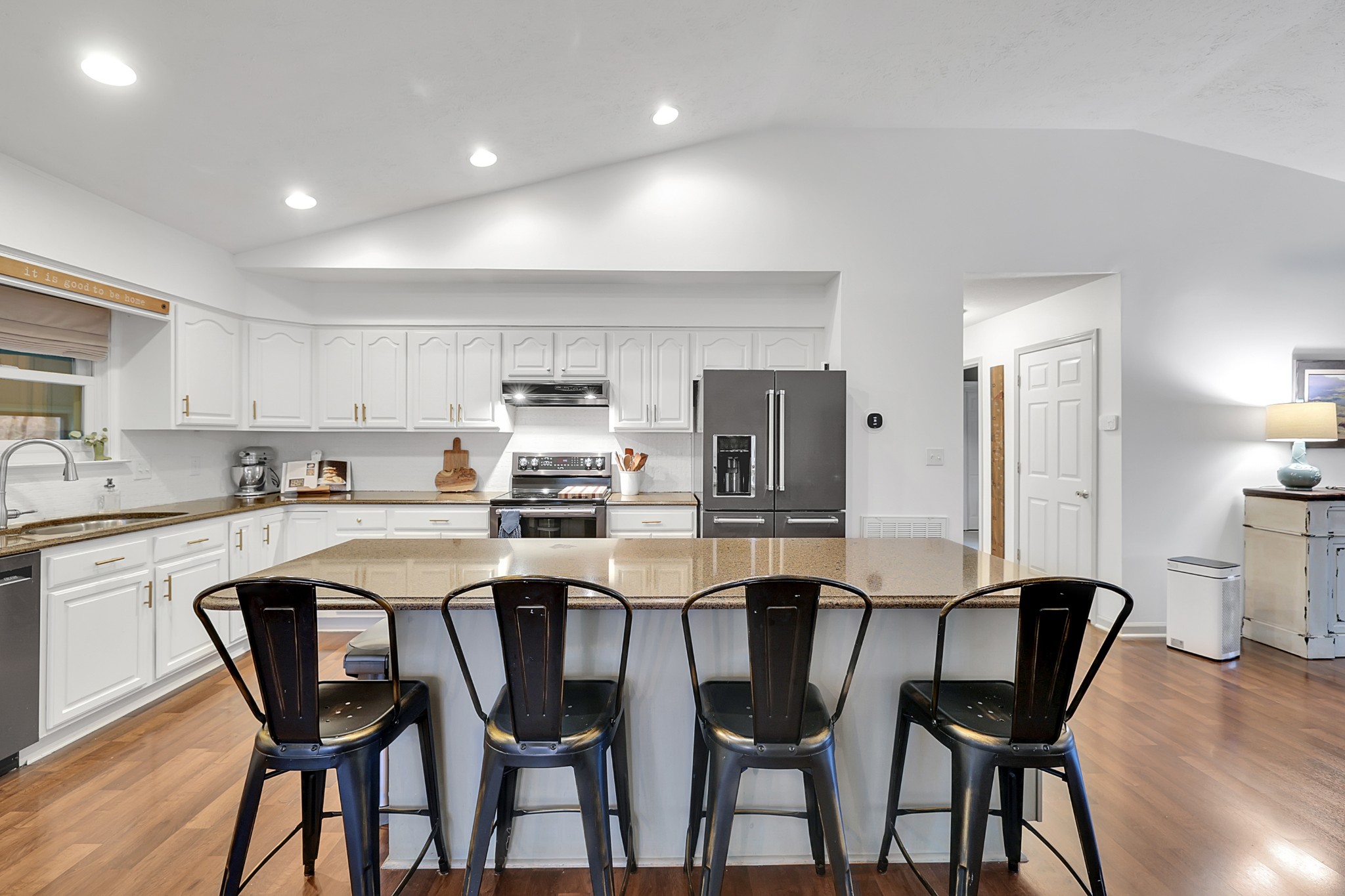 1820 Gravel Hill Road Columbia, TN 38401 - Photo 12 of 37 a kitchen with stainless steel appliances kitchen island granite countertop a table chairs stove and white cabinets