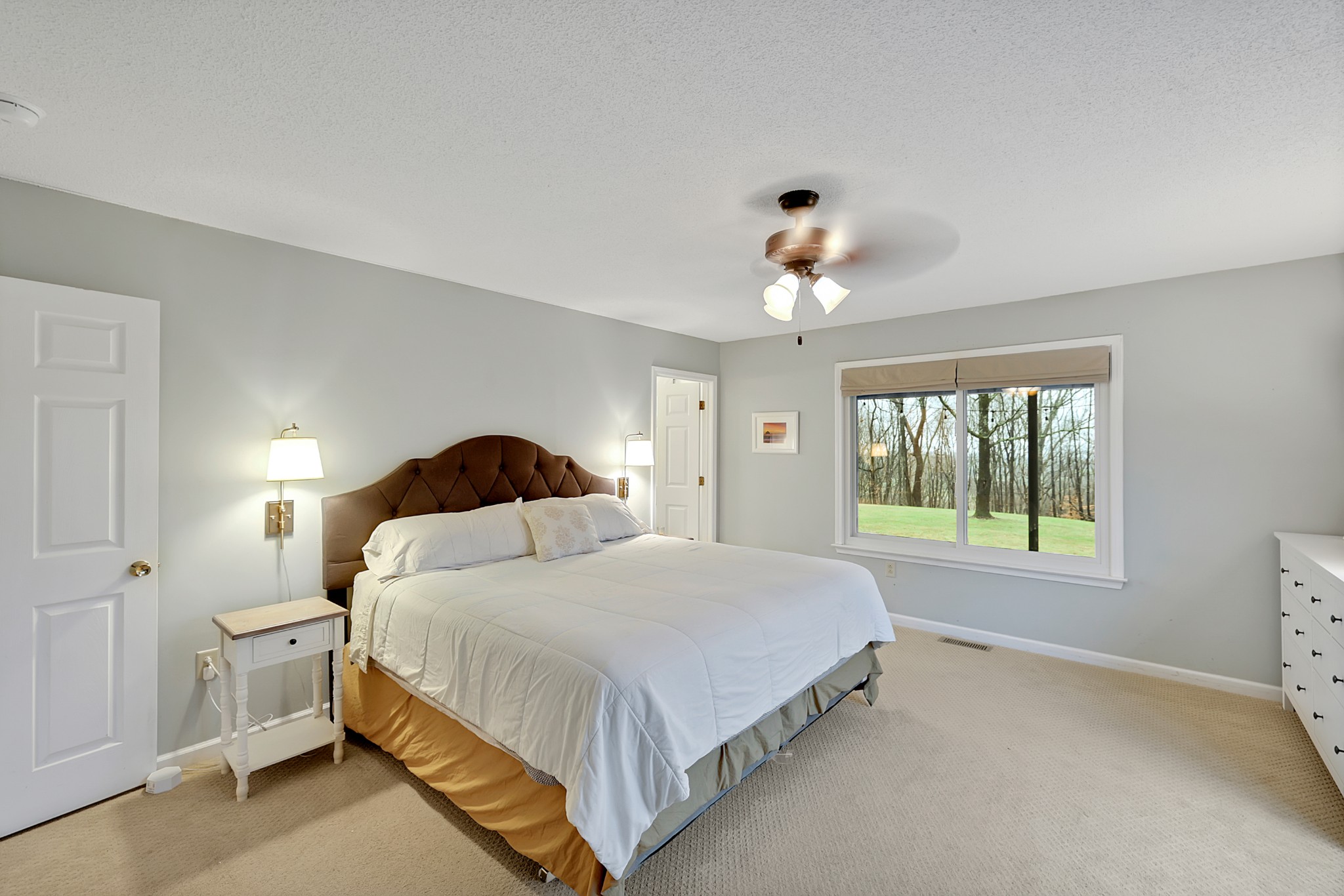 1820 Gravel Hill Road Columbia, TN 38401 - Photo 22 of 37 a bedroom with a large bed and a chandelier