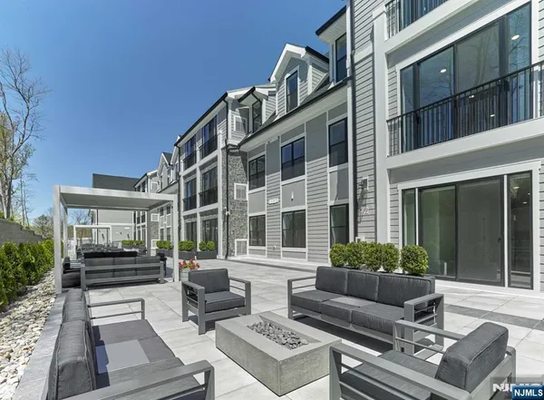 a view of a building with couches potted plants and wooden floor