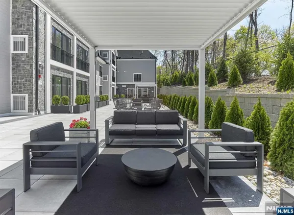 a outdoor living space with patio furniture and a fountain