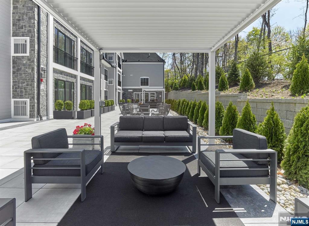 8 Tice Road, Unit 110 Franklin Lakes, NJ 07417 - Photo 2 of 29 a outdoor living space with patio furniture and a fountain