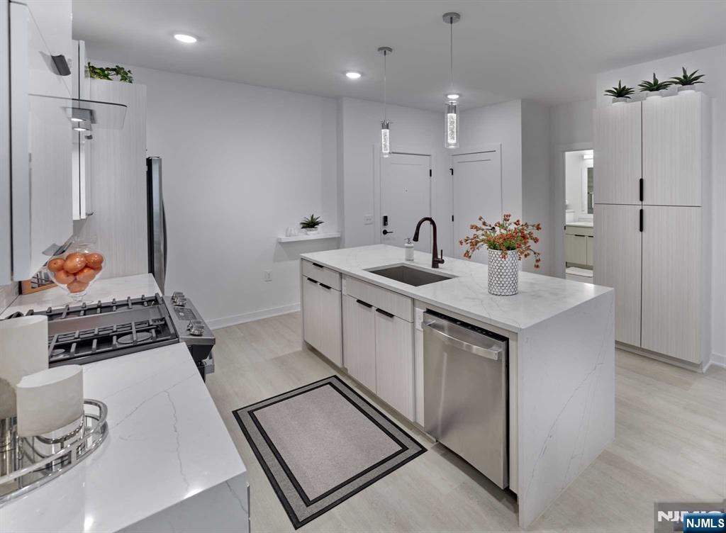 8 Tice Road, Unit 110 Franklin Lakes, NJ 07417 - Photo 5 of 29 a kitchen with stainless steel appliances granite countertop a sink stove and refrigerator