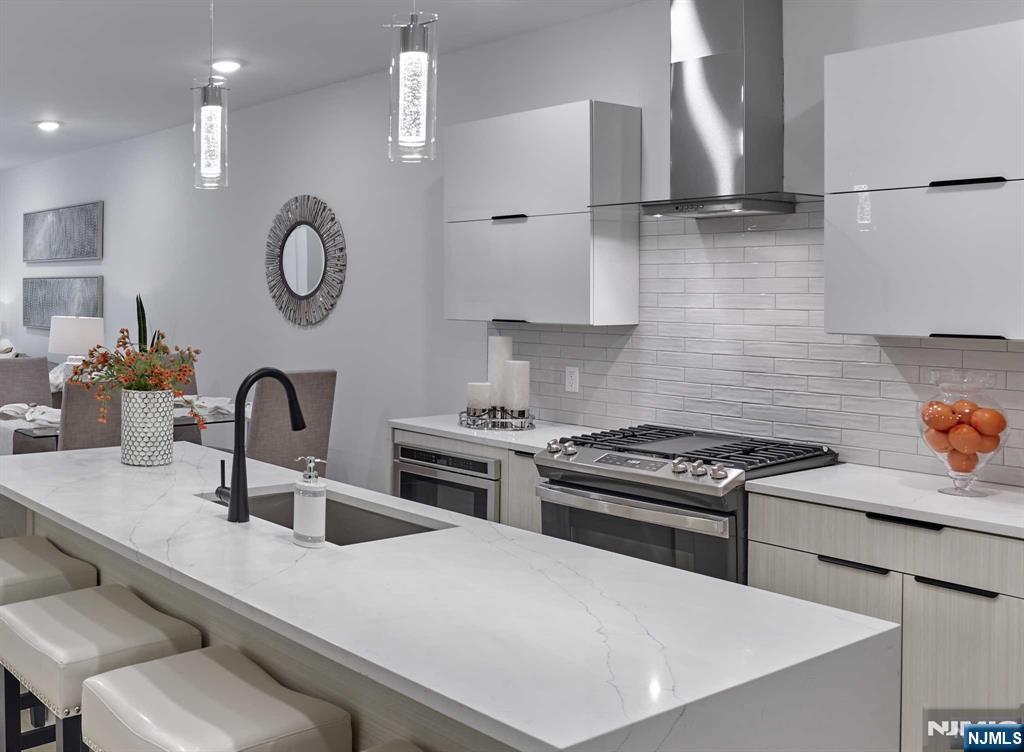 8 Tice Road, Unit 110 Franklin Lakes, NJ 07417 - Photo 6 of 29 a kitchen with stainless steel appliances a sink a stove and a refrigerator