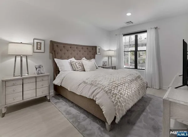 a bedroom with a large bed and a tv