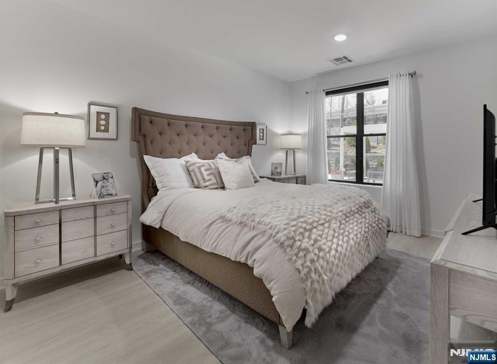 8 Tice Road, Unit 110 Franklin Lakes, NJ 07417 - Photo 7 of 29 a bedroom with a large bed and a tv