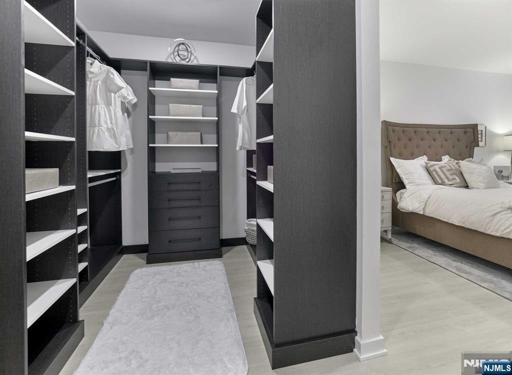 8 Tice Road, Unit 110 Franklin Lakes, NJ 07417 - Photo 8 of 29 a view of walk in closet with clothes and shoes