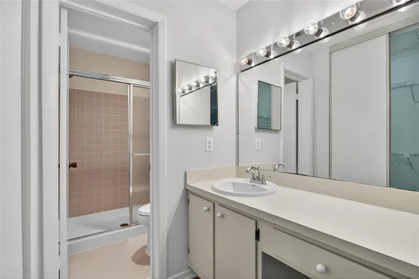 a bathroom with a sink a shower and a mirror