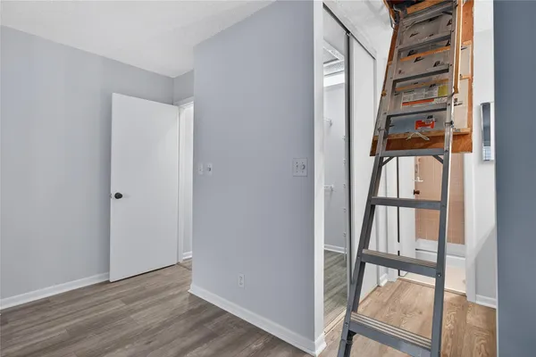 a view of an entryway with wooden floor