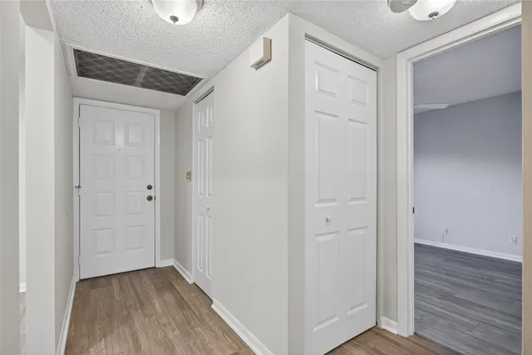 a view of a hallway with wooden floor