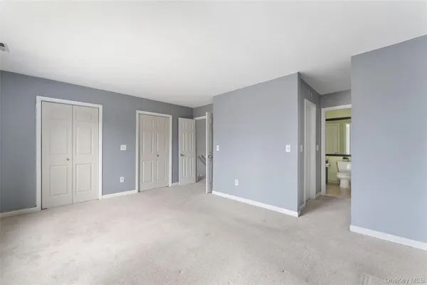 a view of an empty room and closet area