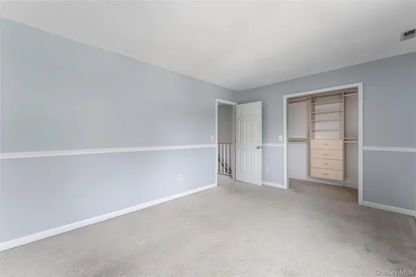 a view of an empty room with closet
