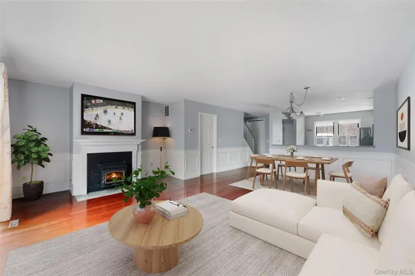 a living room with furniture a fireplace and a potted plant