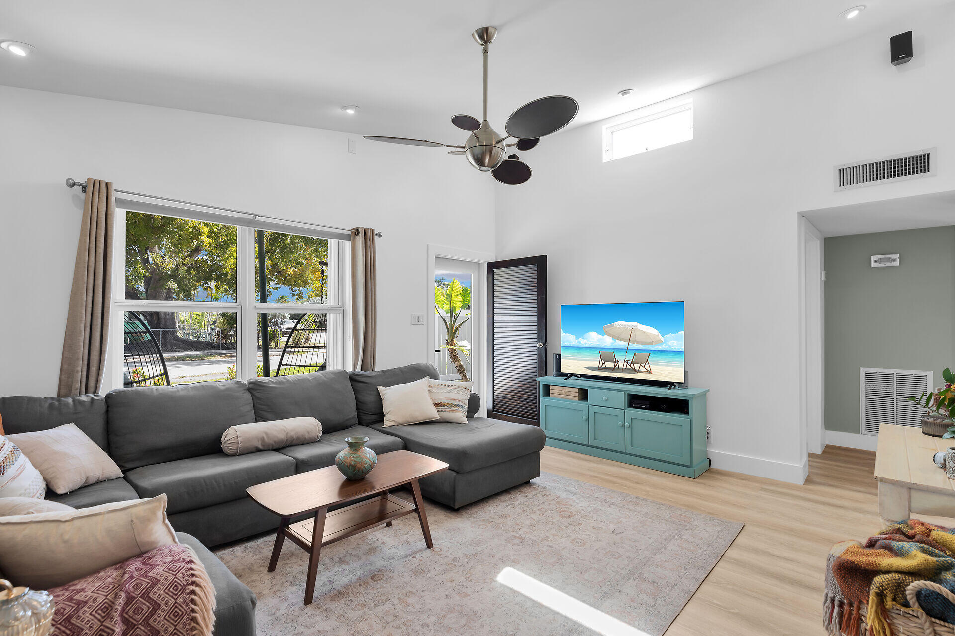 1440 17th Street Key West, FL 33040 - Photo 4 of 37 a living room with furniture a flat screen tv and a large window
