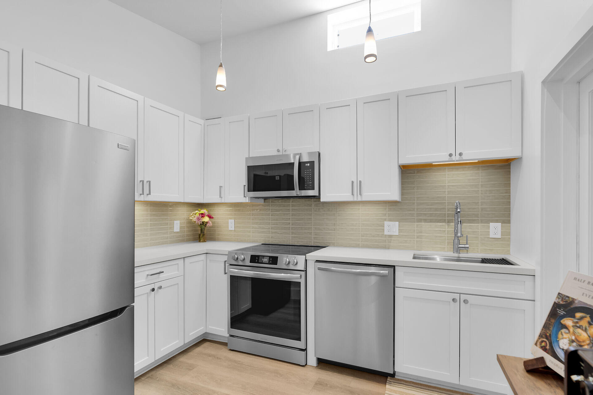 1440 17th Street Key West, FL 33040 - Photo 6 of 37 a kitchen with white cabinets and white appliances