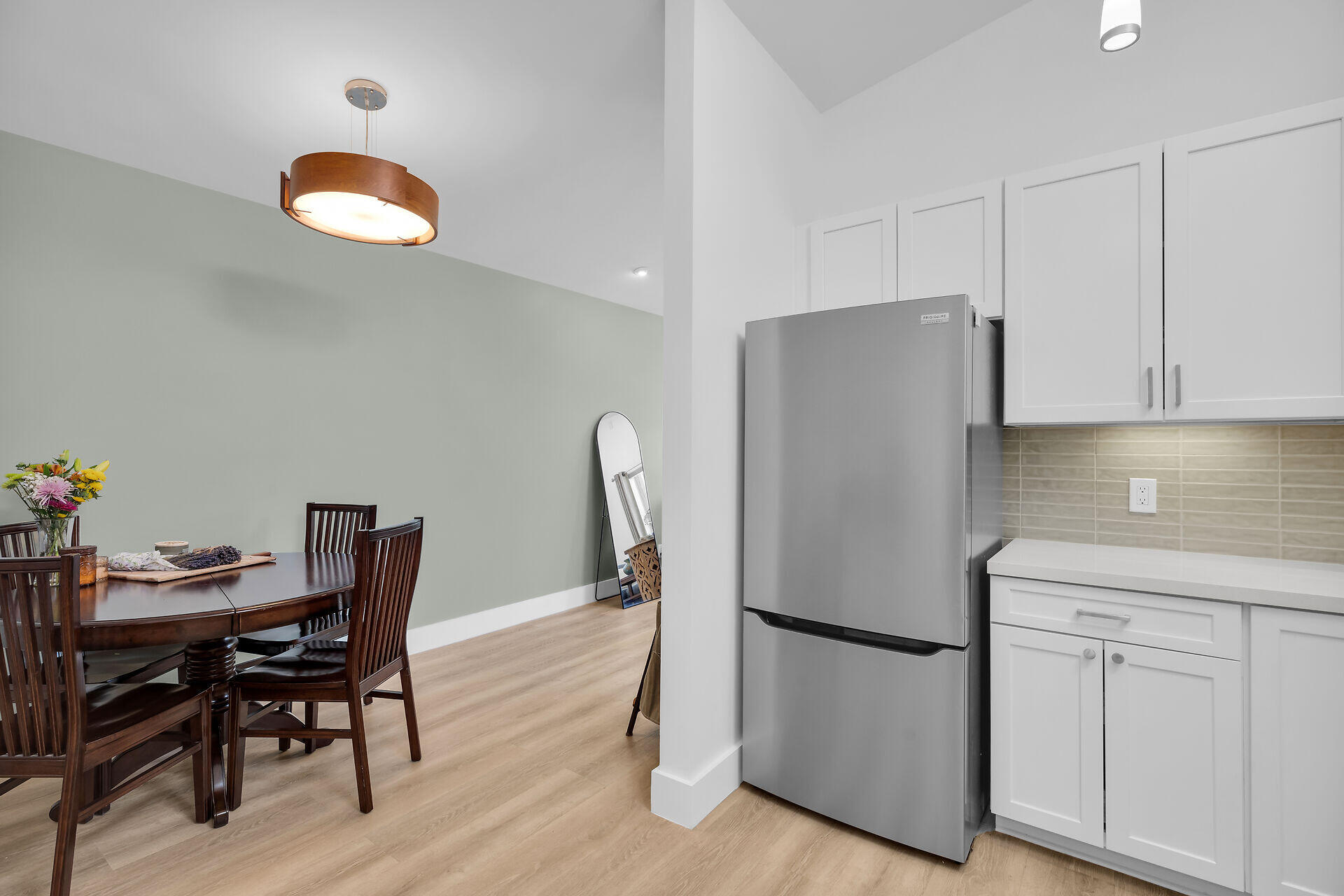 1440 17th Street Key West, FL 33040 - Photo 9 of 37 a kitchen with stainless steel appliances granite countertop a dining table chairs and a refrigerator