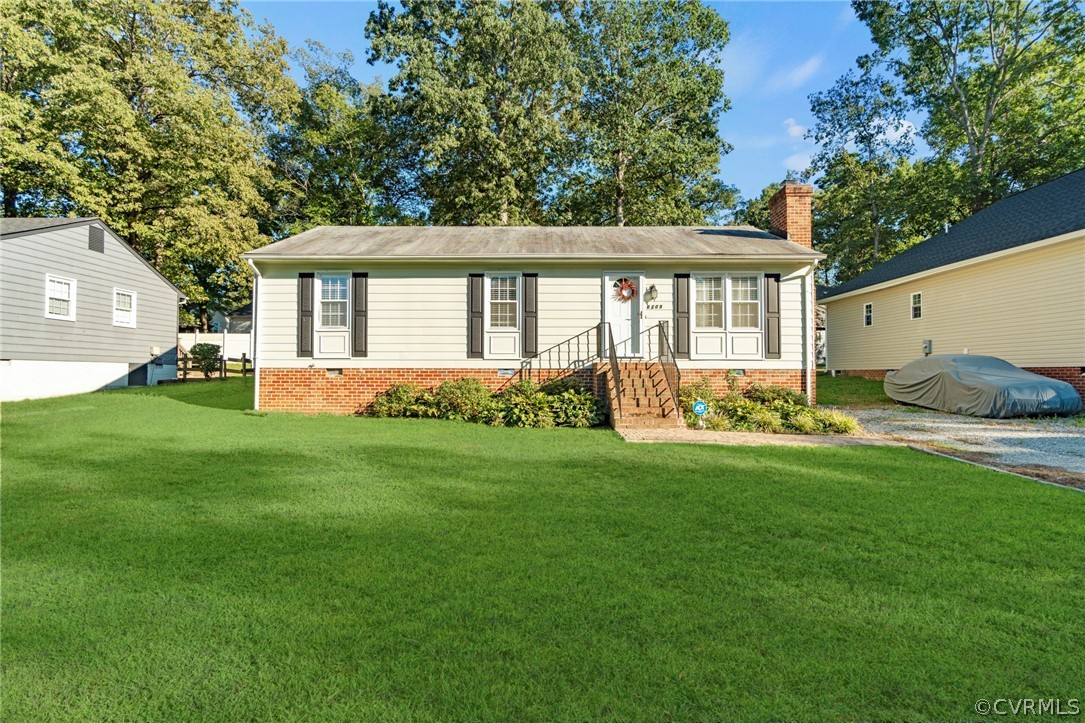 a front view of a house with a garden and yard