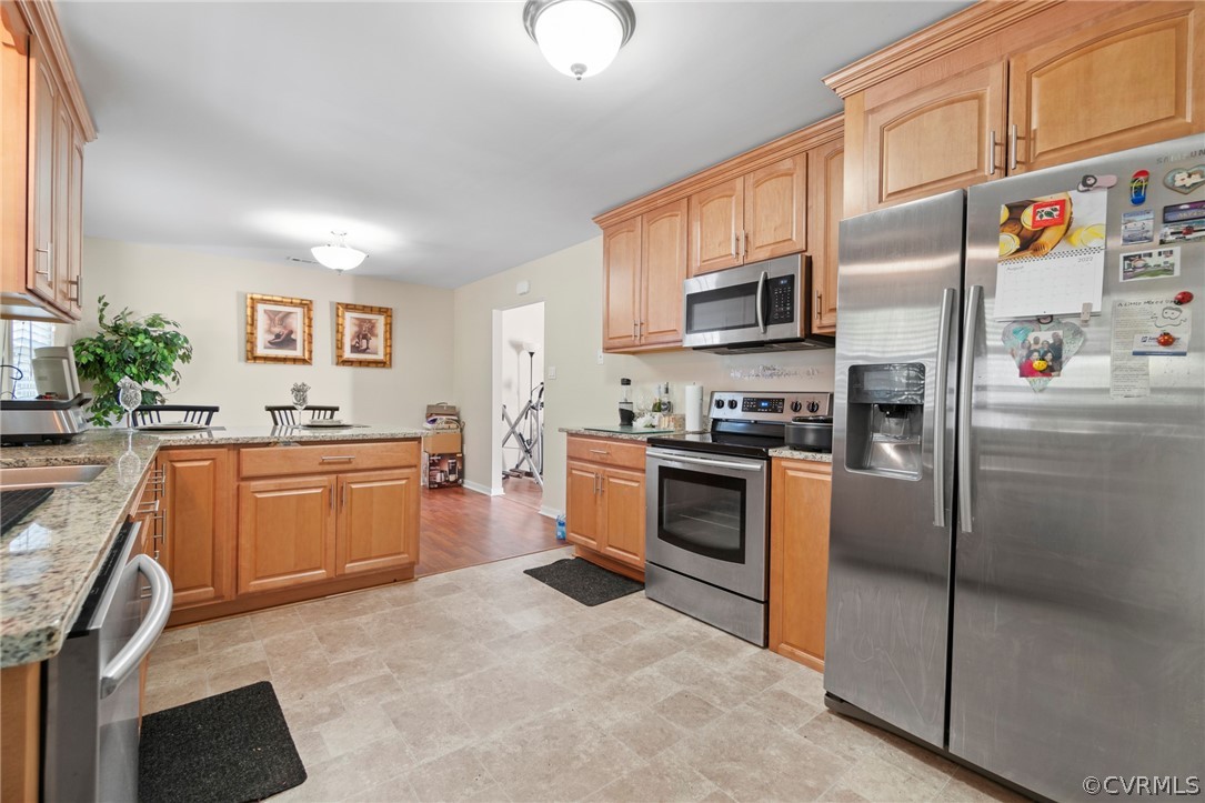 6209 Walderbrook Road Richmond, VA 23234 - Photo 14 of 35 a kitchen with stainless steel appliances granite countertop a refrigerator sink and stove