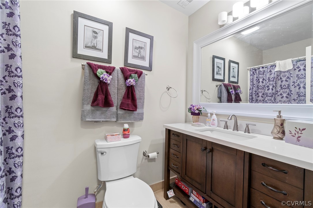 6209 Walderbrook Road Richmond, VA 23234 - Photo 20 of 35 a bathroom with a sink vanity mirror and toilet