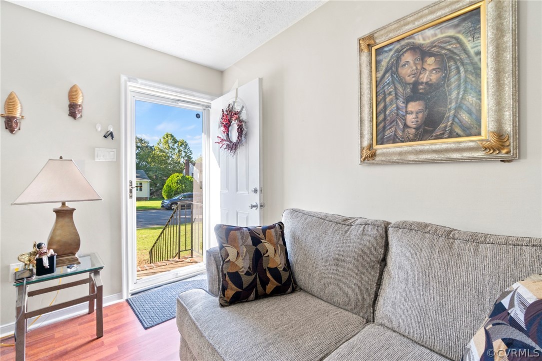 6209 Walderbrook Road Richmond, VA 23234 - Photo 6 of 35 a living room with furniture and a painting on the wall
