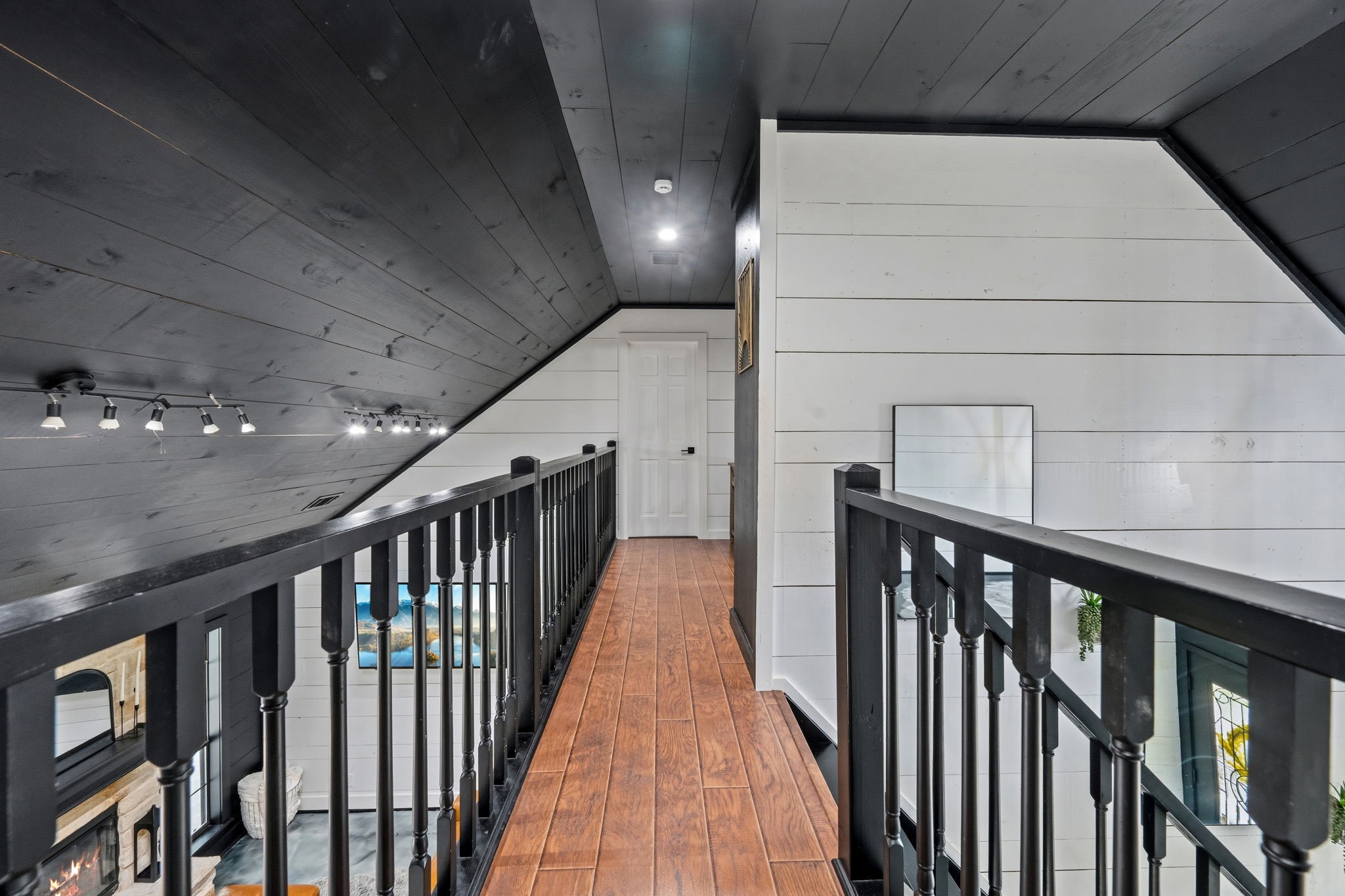 18 East Old Field Road Huffman, TX 77336 - Photo 21 of 35 The elevated upstairs catwalk overlooks the impressive family room below while showcasing dramatic wood-plank ceilings & striking architectural sightlines throughout the home.