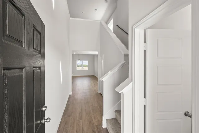 a view of a hallway with wooden floor and entryway