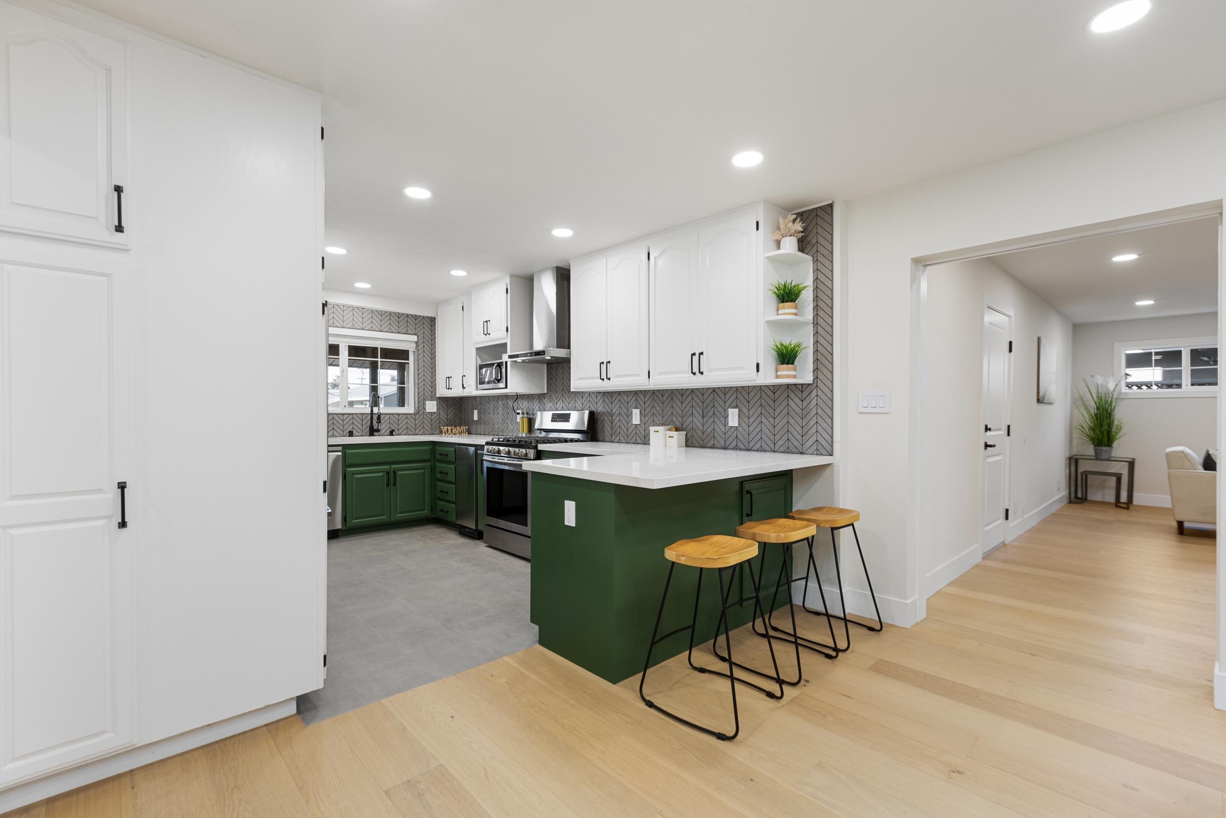 38952 Emrol Avenue Fremont, CA 94536 - Photo 14 of 59 a kitchen with a sink cabinets and wooden floor