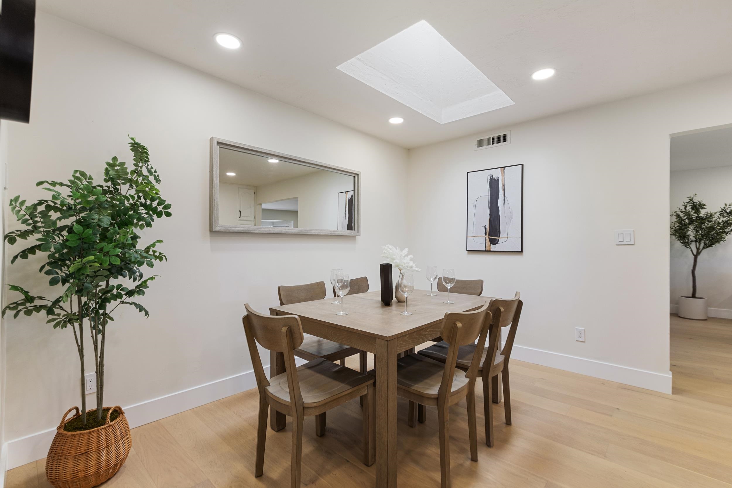 38952 Emrol Avenue Fremont, CA 94536 - Photo 21 of 59 a view of a dining room with furniture and a potted plant