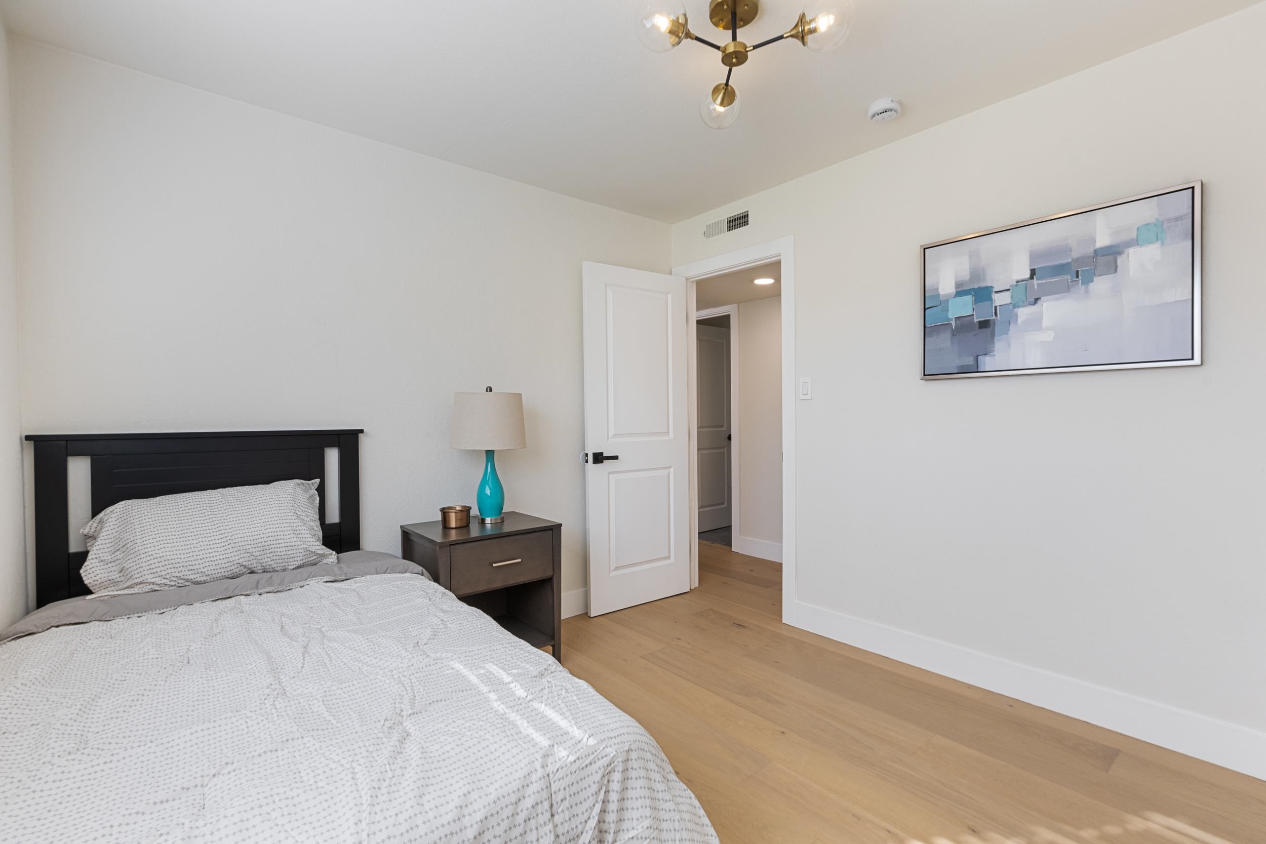 38952 Emrol Avenue Fremont, CA 94536 - Photo 29 of 59 a bedroom with a bed and a painting on the wall